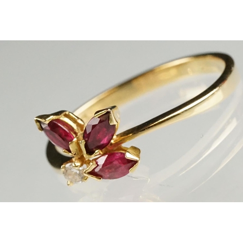 80 - Ruby and diamond 18ct yellow gold ring, three marquise cut rubies, claw set, the principal ruby meas... 