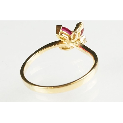 80 - Ruby and diamond 18ct yellow gold ring, three marquise cut rubies, claw set, the principal ruby meas... 