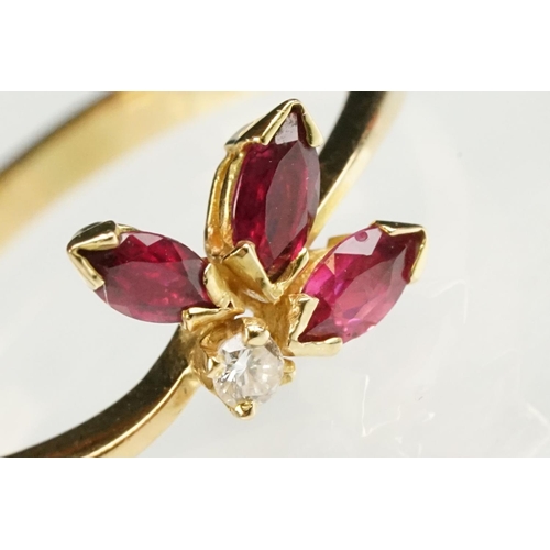 80 - Ruby and diamond 18ct yellow gold ring, three marquise cut rubies, claw set, the principal ruby meas... 