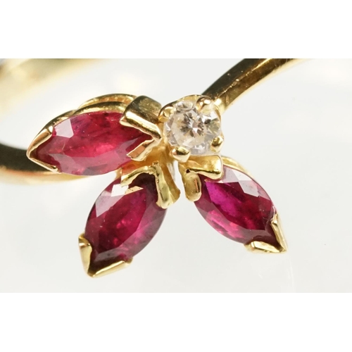 80 - Ruby and diamond 18ct yellow gold ring, three marquise cut rubies, claw set, the principal ruby meas... 