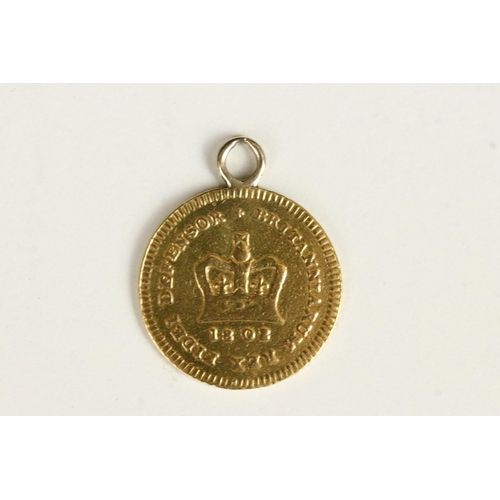 118 - A British King George III gold 1/3 Guinea / Seven Shilling coin with suspension loop mounted to top.