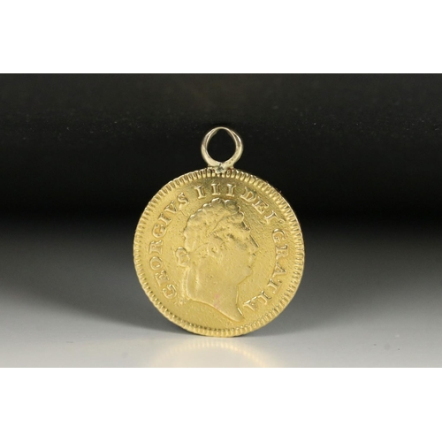 118 - A British King George III gold 1/3 Guinea / Seven Shilling coin with suspension loop mounted to top.