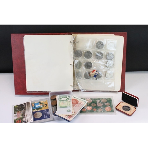 202 - A collection of mainly British coins and banknotes to include commemorative and silver examples.