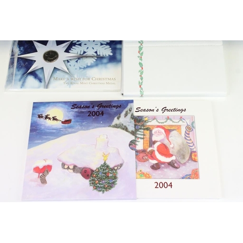 85 - A collection of Royal Mint Christmas coin collectors packs to include 2005, 2004 & 4 x 2008 year set... 