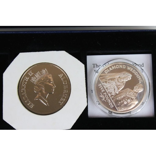 92 - A collection of twelve commemorative crown and £5 coins including silver examples.