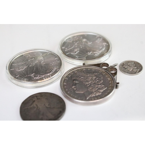 121 - A small collection of United States of America silver coins two include three silver dollars includi... 