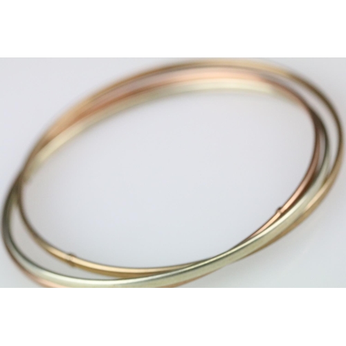 11 - 9ct yellow gold writhen twist hinged bangle together with a rose, yellow and white metal bangle (2)