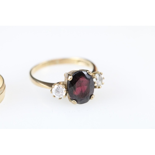 17 - Garnet and white stone 9ct gold three stone ring, size Q½; a 9ct gold wedding band, size Q; together... 