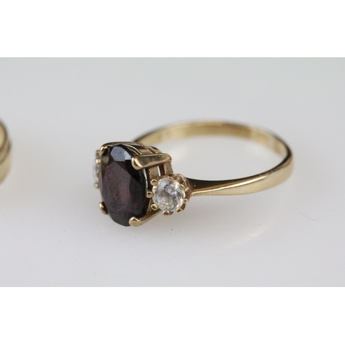 17 - Garnet and white stone 9ct gold three stone ring, size Q½; a 9ct gold wedding band, size Q; together... 