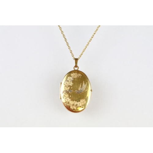 14 - 9ct yellow gold oval locket pendant necklace; together with a 9ct yellow gold helix link chain neckl... 