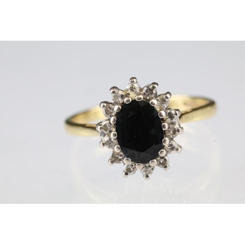 16 - Sapphire and diamond 18ct yellow gold cluster ring, blue-black oval mixed cut sapphire, small round ... 