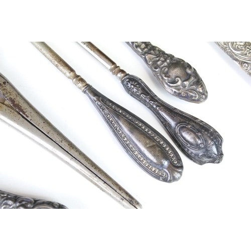 659 - Silver handled items to include two pairs of glove stretchers, a shoe horn, four button hooks, Irish... 