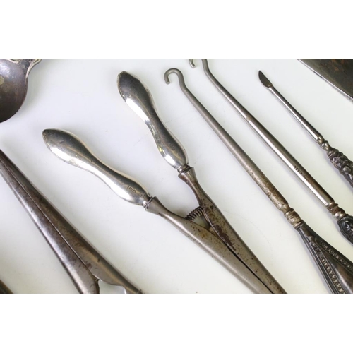 659 - Silver handled items to include two pairs of glove stretchers, a shoe horn, four button hooks, Irish... 