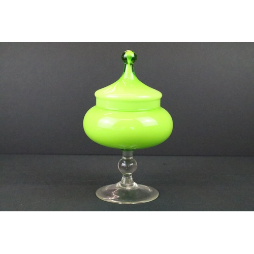 22 - Three pieces of 20th century coloured glass to include a green vase of bulbous form, green glass foo... 