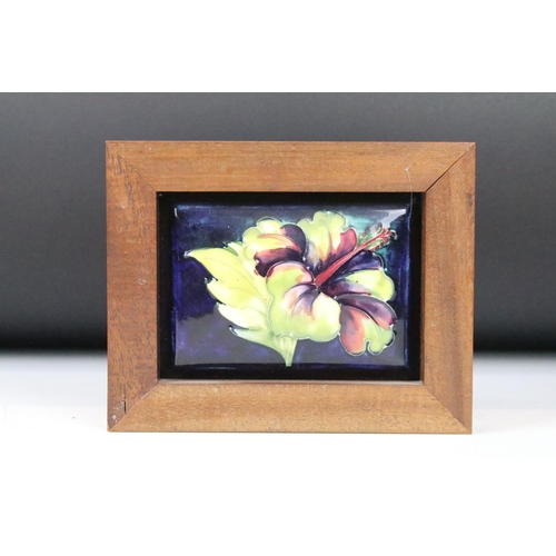 6 - Four Moorcroft ceramic framed mounted ceramic lids to include a hibiscus pattern plaque, two clemati... 