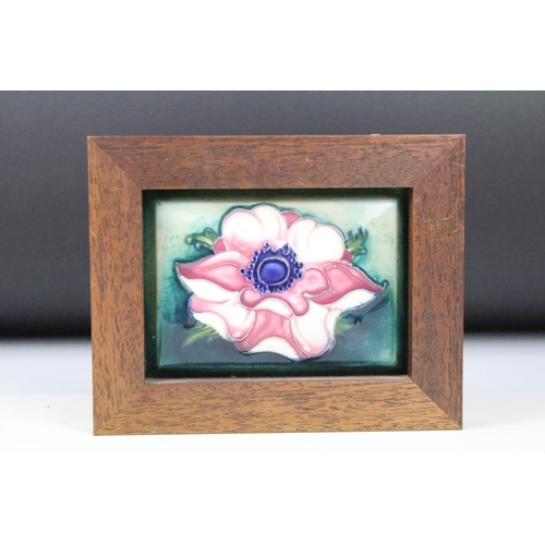 6 - Four Moorcroft ceramic framed mounted ceramic lids to include a hibiscus pattern plaque, two clemati... 