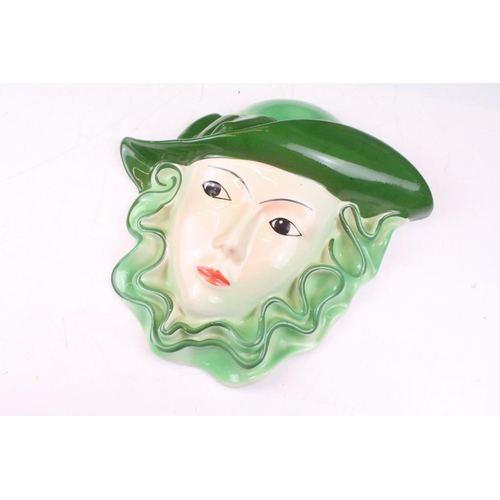 28 - Two Crown Devon pottery wall masks, painted by Dorothy Ann, measure approx 24.5cm high