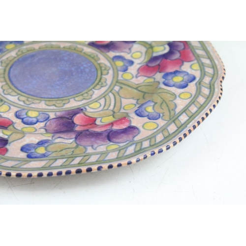 37 - Charlotte Rhead for Crown Ducal shaped circular plate, tube lined with stylised flowerheads, blue da... 