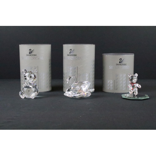 62 - Three Swarovski crystal figurines to include a swan, Kris bear on skates and a teddy bear, all in or... 