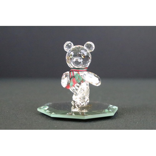 62 - Three Swarovski crystal figurines to include a swan, Kris bear on skates and a teddy bear, all in or... 