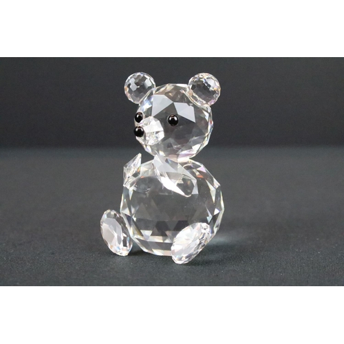 62 - Three Swarovski crystal figurines to include a swan, Kris bear on skates and a teddy bear, all in or... 