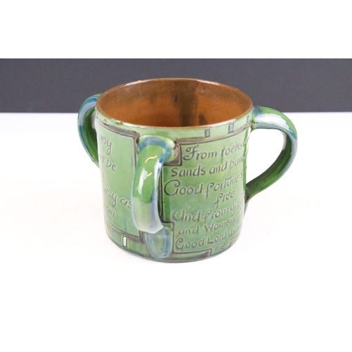 64 - Early 20th Century C H Brannam Barum tyg three handled loving cup having engraved with verso / motto... 