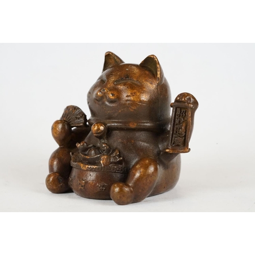 221 - An ornamental Japanese bronze 招き猫 / maneki-neko (waving / beckoning) lucky cat talisman.