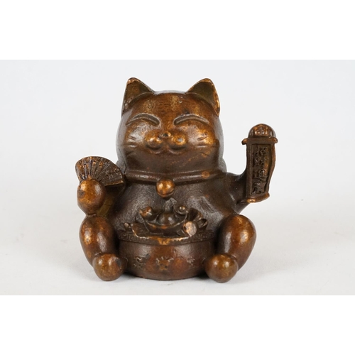 221 - An ornamental Japanese bronze 招き猫 / maneki-neko (waving / beckoning) lucky cat talisman.