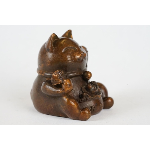 221 - An ornamental Japanese bronze 招き猫 / maneki-neko (waving / beckoning) lucky cat talisman.