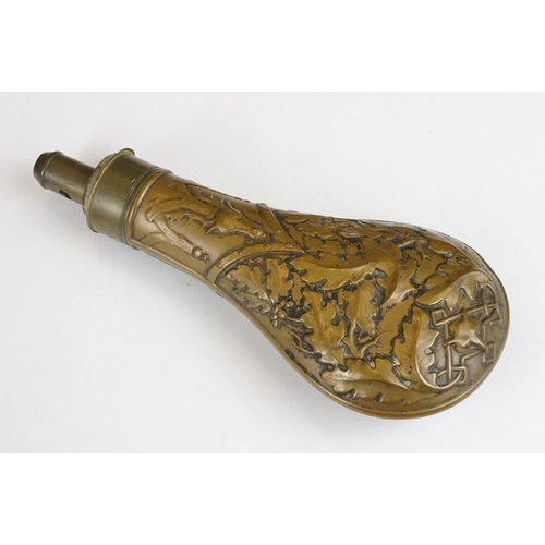 226 - An antique brass powder flask with oak leaf and stag decoration.