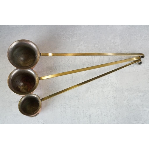 118 - Set of three graduating copper measures with hanging handles, to include Whisky, Rum & Brandy. (Larg... 