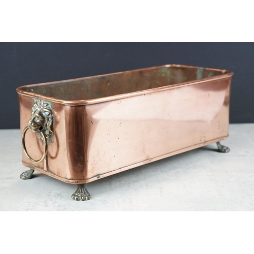 120 - Copper planter of rectangular form, with rolled upper rim, twin lion mask loop handles, raised on fo... 