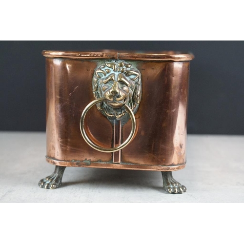 120 - Copper planter of rectangular form, with rolled upper rim, twin lion mask loop handles, raised on fo... 