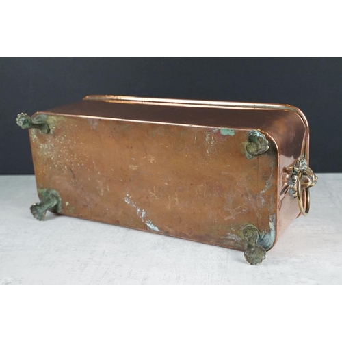 120 - Copper planter of rectangular form, with rolled upper rim, twin lion mask loop handles, raised on fo... 