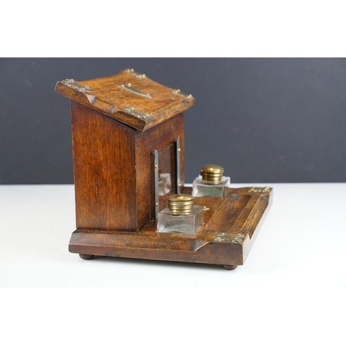 130 - Late 19th / early 20th century oak double inkwell desk stand with letter box, the glass inkwells wit... 