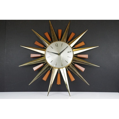 132 - Mid 20th C Metamec brass & teak sunburst wall clock, the silvered dial with applied Arabic numerals.... 