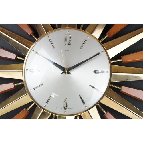 132 - Mid 20th C Metamec brass & teak sunburst wall clock, the silvered dial with applied Arabic numerals.... 