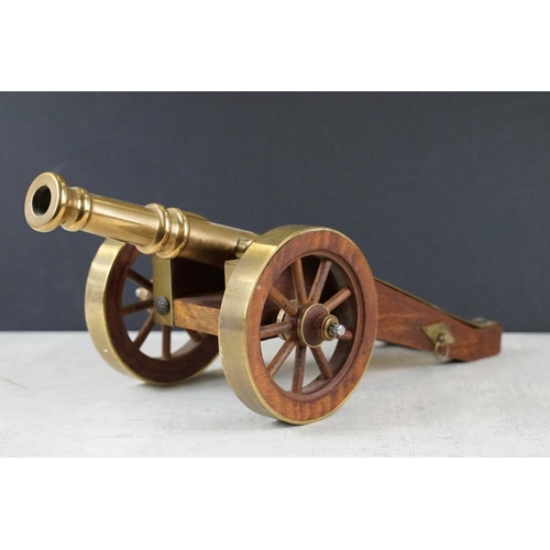 134 - Bronze, Brass and Teak Desk Ornament in the form of a Cannon, 38cms long