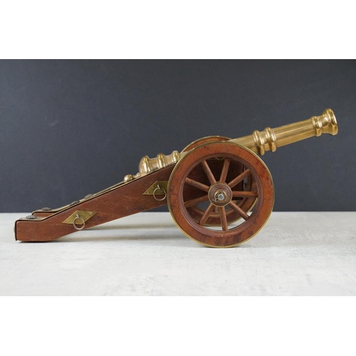 134 - Bronze, Brass and Teak Desk Ornament in the form of a Cannon, 38cms long