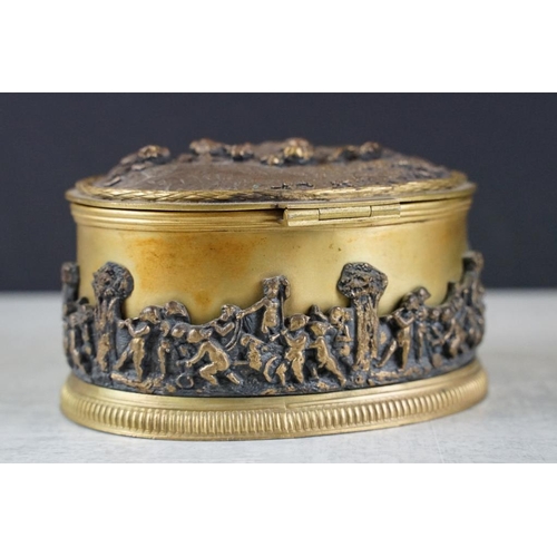 135 - A decorative gilt metal jewellery box / casket with figural decoration. Measures approx 13cm wide