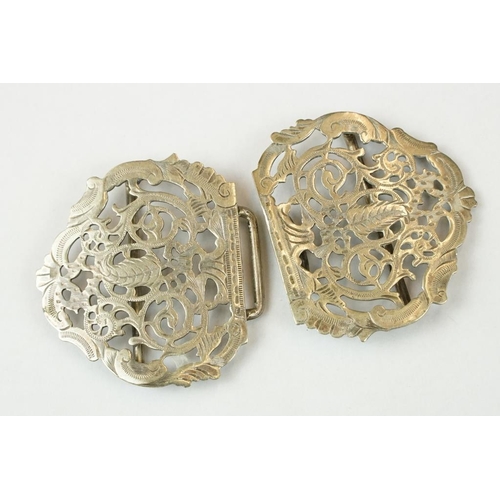 352 - An antique silver plated nurses belt buckle together with a quantity of badges to include military e... 