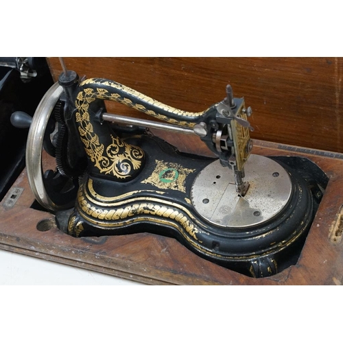 436 - Victorian cast iron table top sewing machine with typical gilt decoration, approx 36cm long, wooden ... 