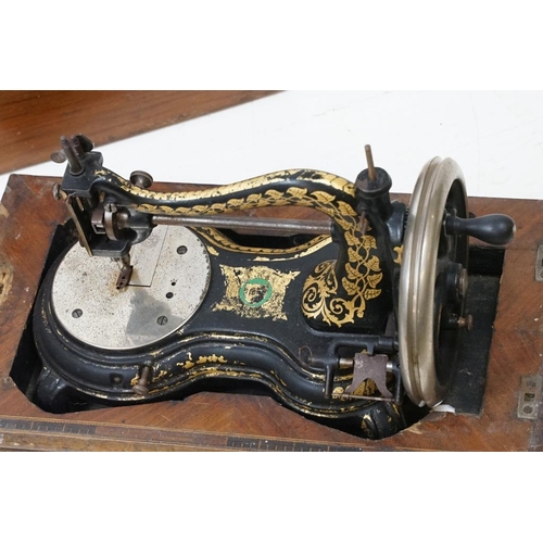 436 - Victorian cast iron table top sewing machine with typical gilt decoration, approx 36cm long, wooden ... 