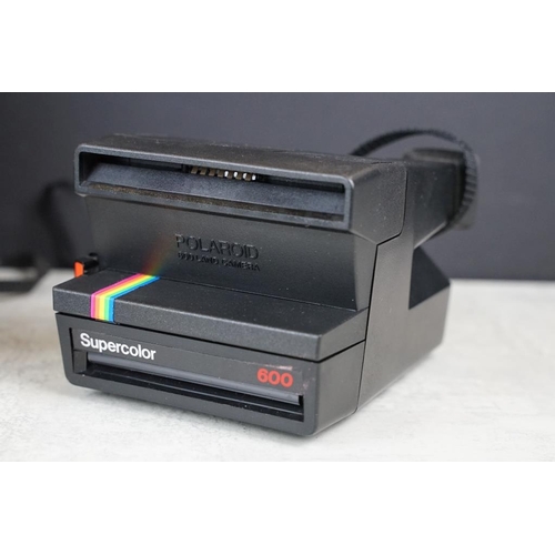 427 - Three polaroid cameras to include The Button Polaroid Land camera, 600 land camera supercolor and Po... 