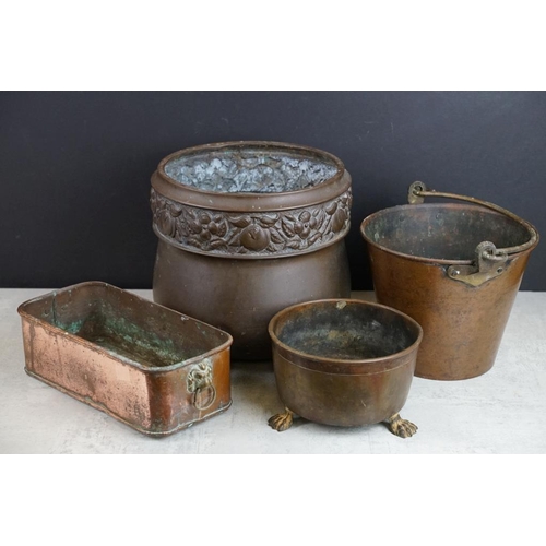 432 - Copper planter with twin lion mask handles (27cm long), together with a brass planter with embossed ... 