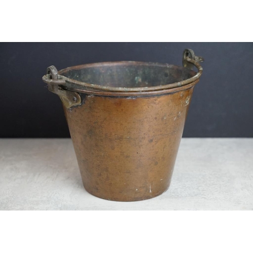 432 - Copper planter with twin lion mask handles (27cm long), together with a brass planter with embossed ... 