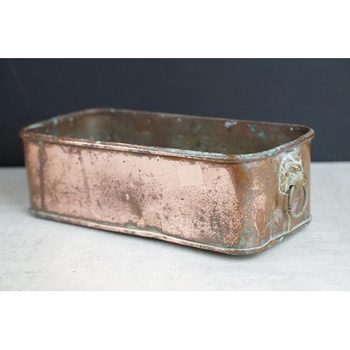 432 - Copper planter with twin lion mask handles (27cm long), together with a brass planter with embossed ... 