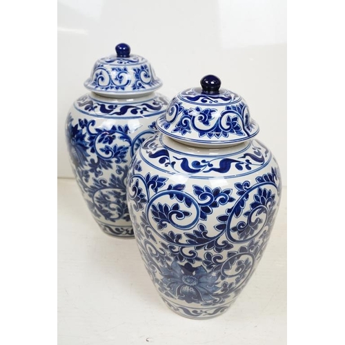 48 - Pair of 20th century Chinese style blue and white vases & covers, of ovoid form, with underglaze flo... 