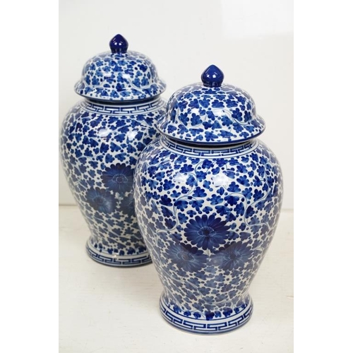 49 - Pair of 20th century blue & white vases and covers, of baluster form, with floral and foliate decora... 