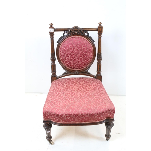 698 - Edwardian Mahogany Nursing Chair, the oval upholstered splat with ribbon carving, upholstered stuff-... 